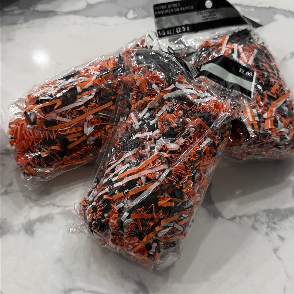 Three bags of black and orange shredded paper Halloween party bag material